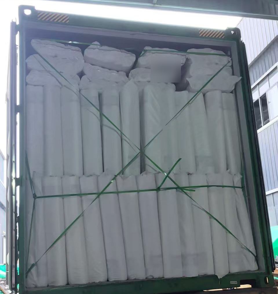 Rolls of fiberglass mesh loaded and strapped in a container